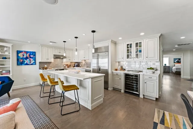 a kitchen with stainless steel appliances kitchen island granite countertop a sink and cabinets