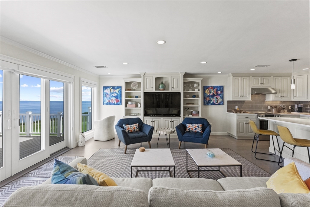 64 Cliffside Drive, Unit 64 Plymouth, MA 02360 - Photo 7 of 42 a living room with furniture a flat screen tv and a fireplace