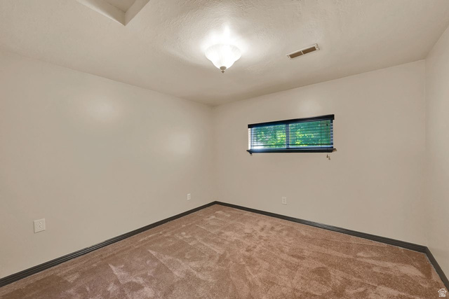 655 Ogden Canyon Road Ogden, UT 84401 - Photo 24 of 50 Interior room featuring light-toned walls, a brown carpeted floor, and dark baseboards