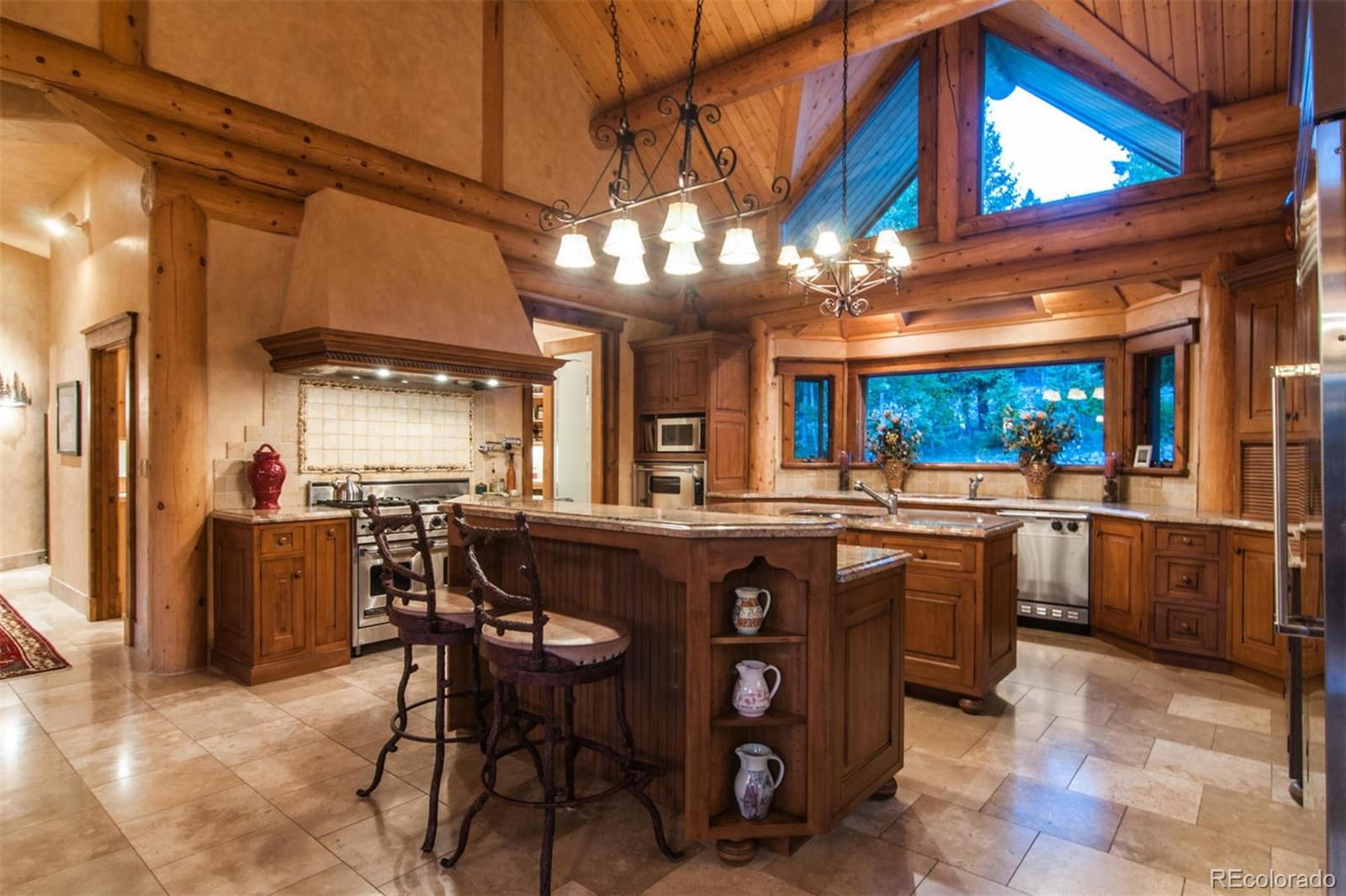 590 West Meadow Road Evergreen, CO 80439 - Photo 13 of 40 a view of a dining room with furniture and chandelier