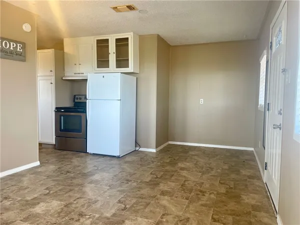a kitchen with cabinets appliances and a sink