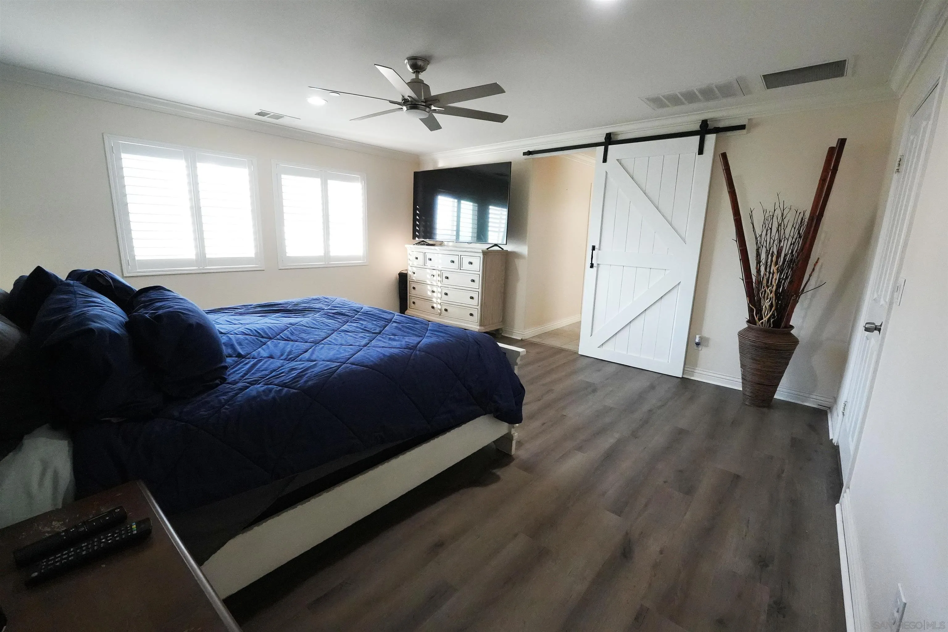 3326 Crowfoot Road San Bernardino, CA 92407 - Photo 12 of 20 a spacious bedroom with a bed window and a ceiling fan