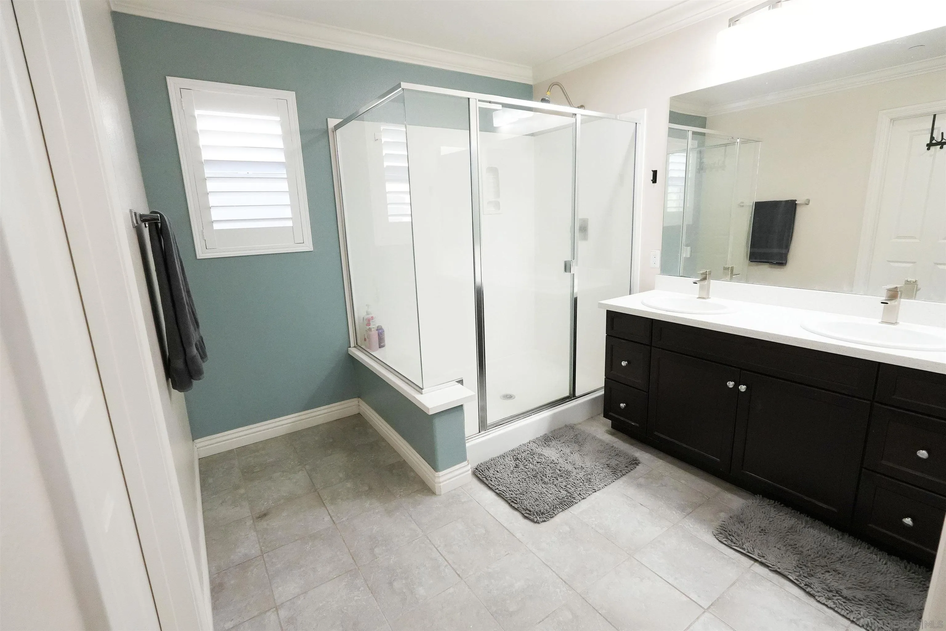 3326 Crowfoot Road San Bernardino, CA 92407 - Photo 19 of 20 a spacious bathroom with a double vanity sink a mirror and a shower