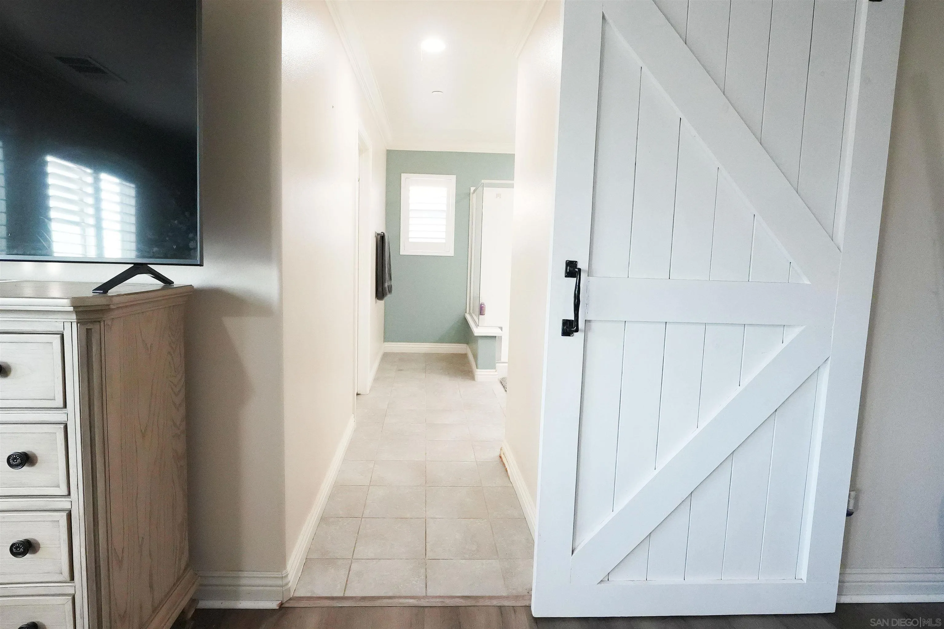 3326 Crowfoot Road San Bernardino, CA 92407 - Photo 20 of 20 a view of a hallway with wooden floor and staircase