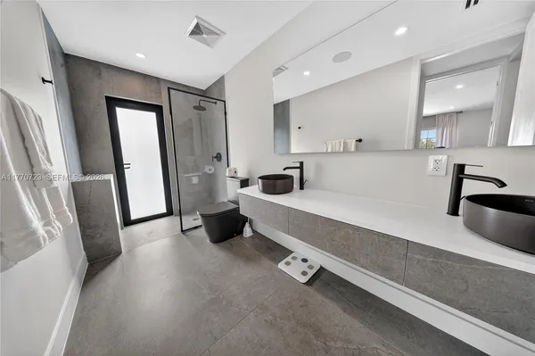 a bedroom with a large bed and a flat screen tv