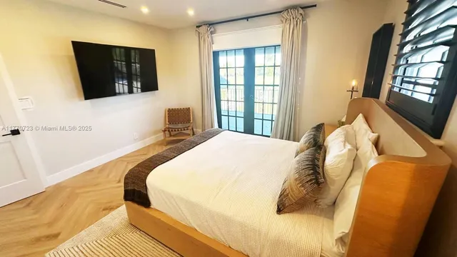 swimming pool with lawn chairs and large trees