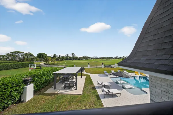 a kitchen with stainless steel appliances granite countertop a stove a refrigerator a oven a dining table and chairs with wooden floor