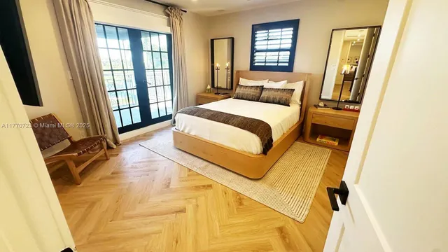 a view of a patio with couches chairs potted plants and a palm tree