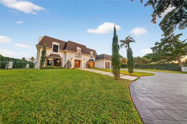 a house view with a swimming pool and yard