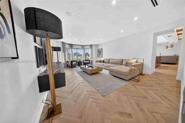 a living room with furniture a fireplace and a large window