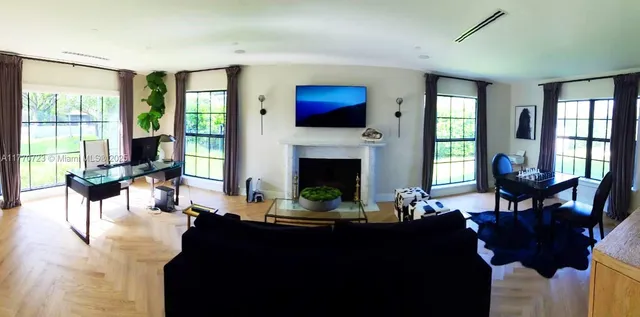 a large bed in a bedroom next to a window