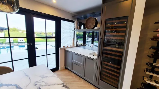 a bedroom with a bed flat screen tv and a large window