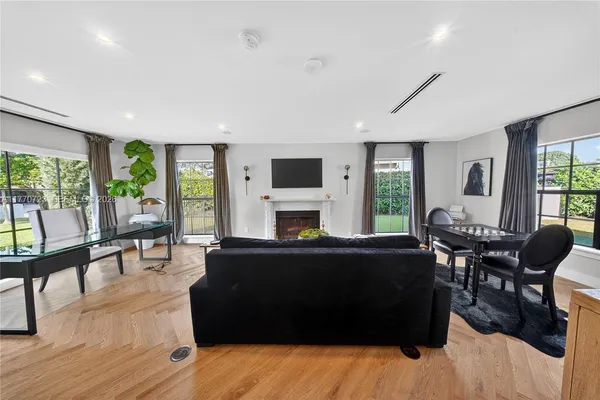 a view of a hallway to rooms and stairs