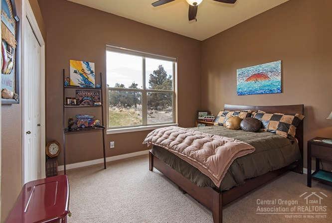 23095 Alfalfa Market Road Bend, OR 97701 - Photo 12 of 25 a bed sitting in a bedroom next to a window