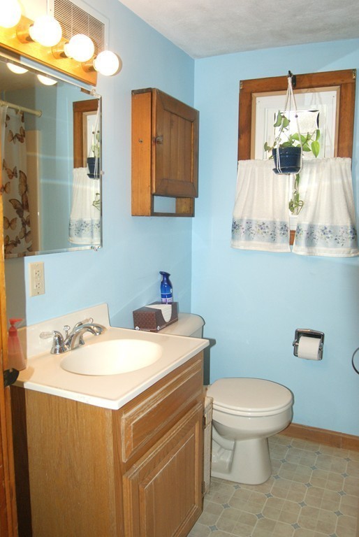 187-191 Shepard Road Sturbridge, MA 01566 - Photo 12 of 18 a bathroom with a sink a toilet and a mirror
