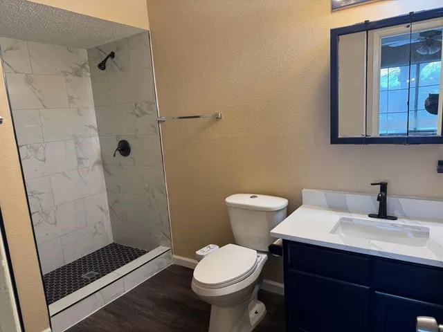 a bathroom with a sink toilet and shower