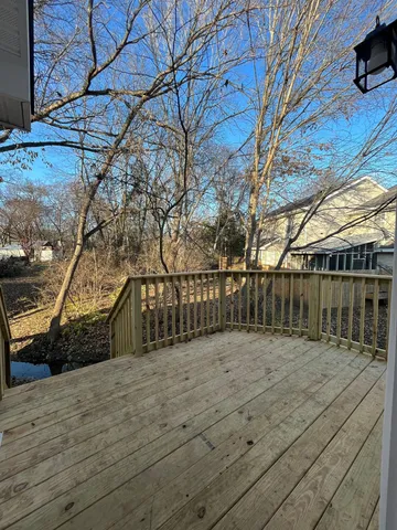 a view of pathway with wooden fence