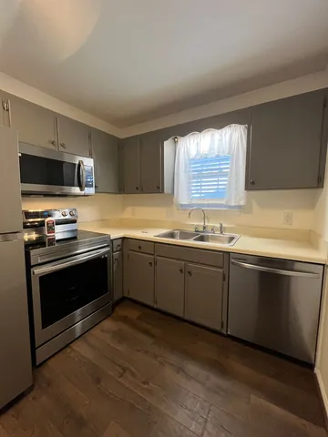 a kitchen with granite countertop a sink and steel appliances