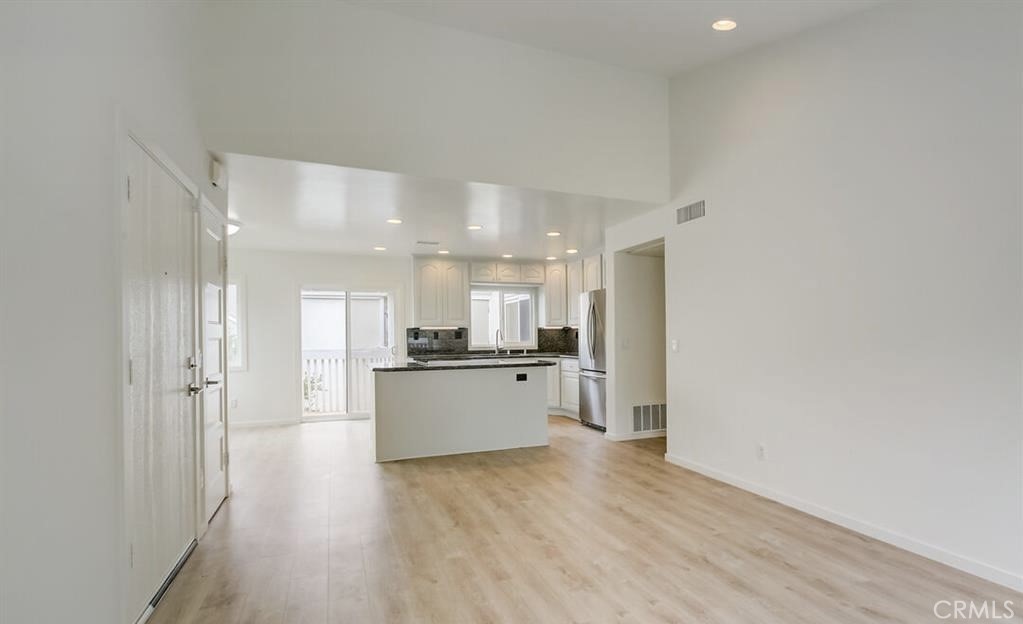 34028 Selva Road, Unit 77 Dana Point, CA 92629 - Photo 11 of 62 a large white kitchen with a sink and dishwasher a refrigerator with wooden floor