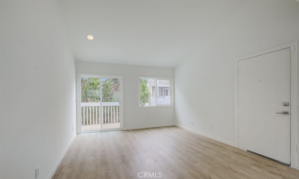 34028 Selva Road, Unit 77 Dana Point, CA 92629 - Photo 13 of 62 an empty room with wooden floor and windows