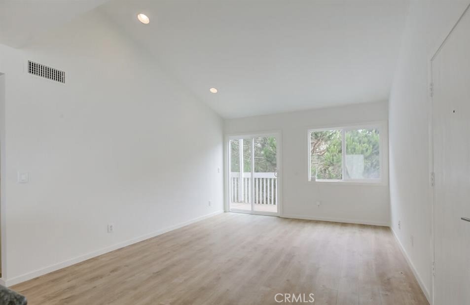 34028 Selva Road, Unit 77 Dana Point, CA 92629 - Photo 16 of 62 an empty room with wooden floor and windows