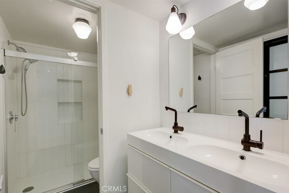 34028 Selva Road, Unit 77 Dana Point, CA 92629 - Photo 24 of 62 a bathroom with a sink a toilet and a mirror