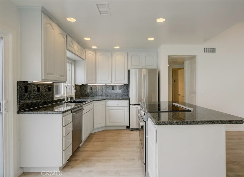 34028 Selva Road, Unit 77 Dana Point, CA 92629 - Photo 9 of 62 a kitchen with stainless steel appliances granite countertop a refrigerator a stove and a sink