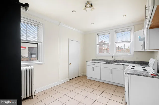 a kitchen with a sink cabinets and window