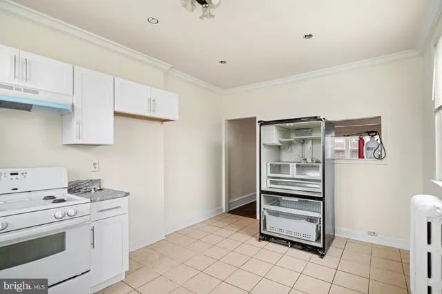 a kitchen with stainless steel appliances a stove and cabinets