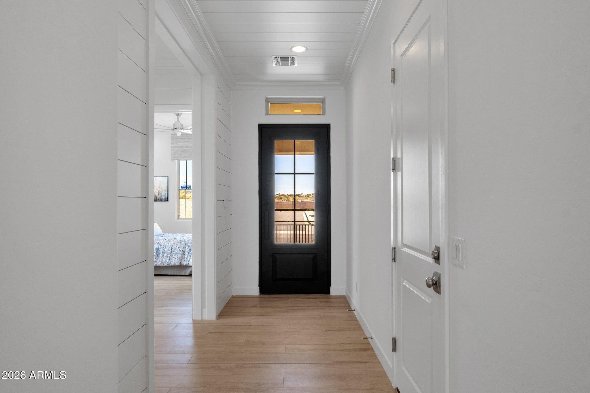 3706 East Rochelle Circle Mesa, AZ 85213 - Photo 3 of 9 a view of a hallway with wooden floor and windows