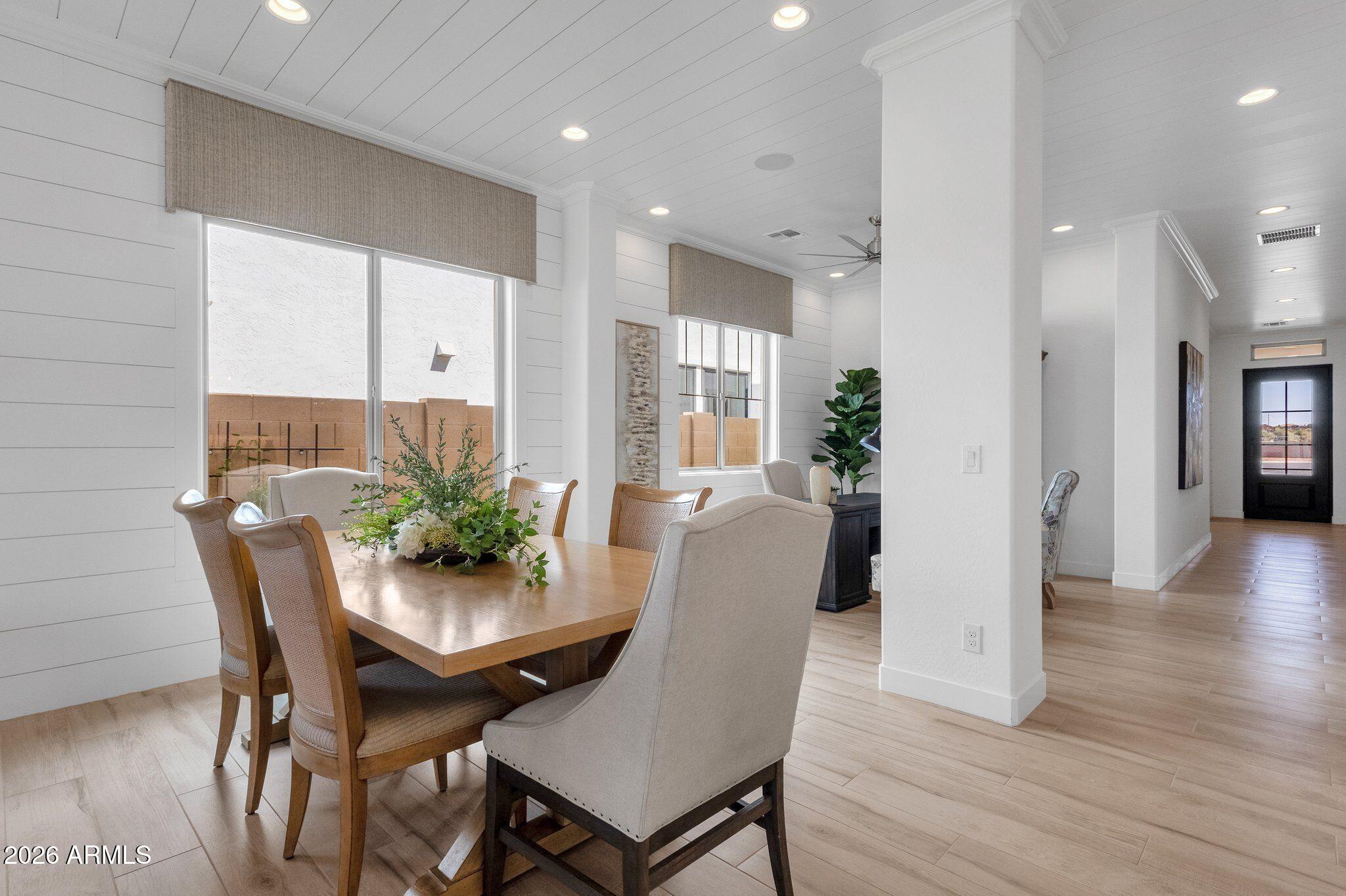 3706 East Rochelle Circle Mesa, AZ 85213 - Photo 6 of 9 a view of a dining room with furniture and wooden floor