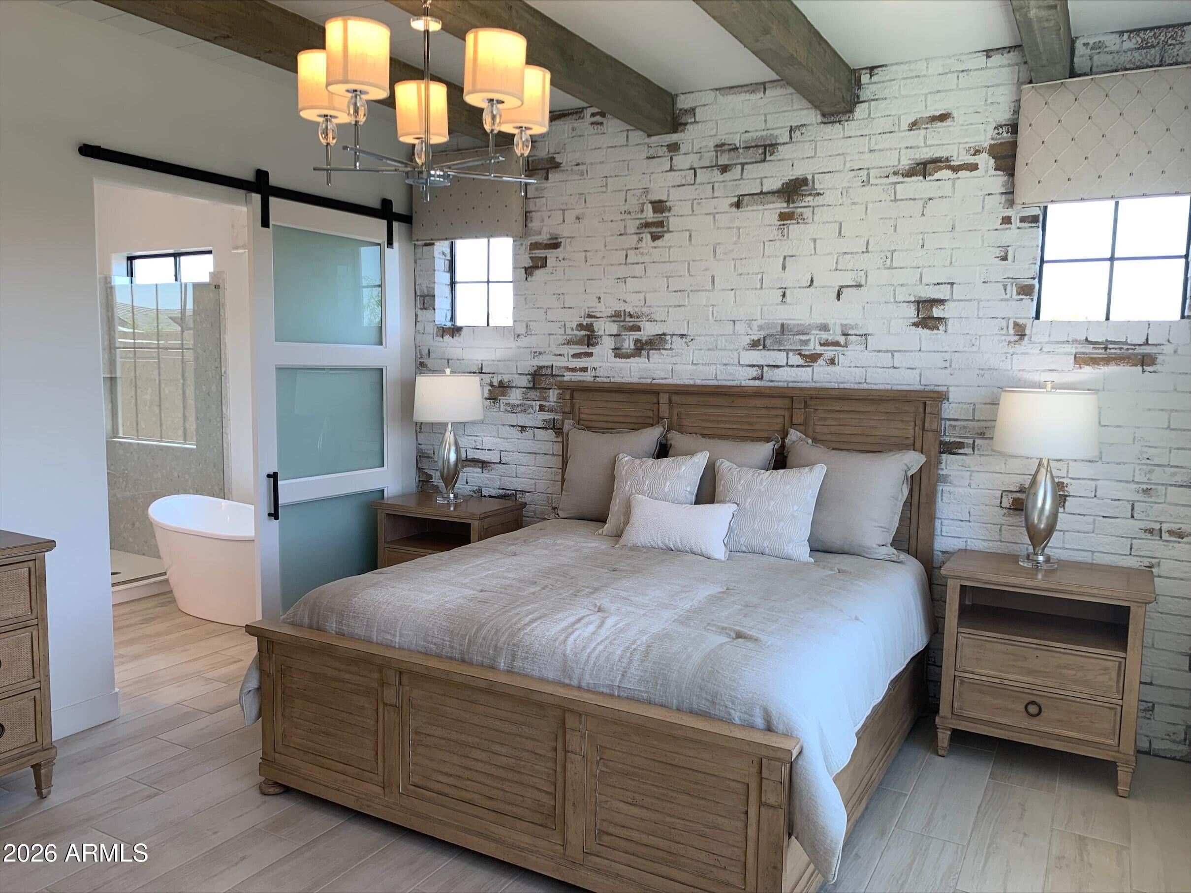 3706 East Rochelle Circle Mesa, AZ 85213 - Photo 8 of 9 a bedroom with a bed a chandelier and dresser