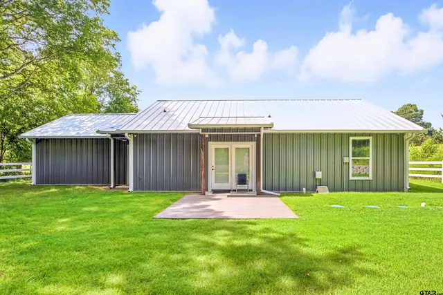 a front view of a house with a yard and porch