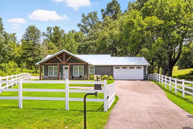 a front view of a house with a yard table and chairs