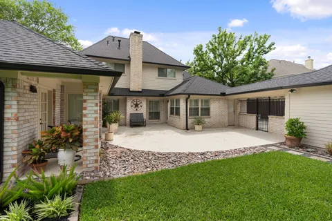 a front view of a house with a garden and plants
