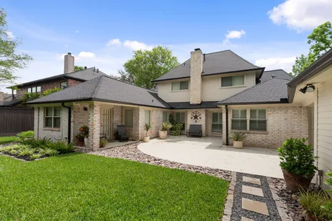 a front view of a house with a yard and porch