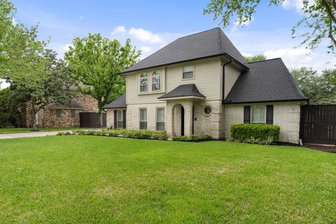 a front view of a house with a garden and yard