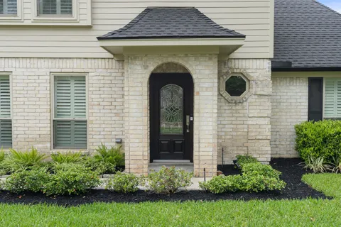 a view of a house with potted plants