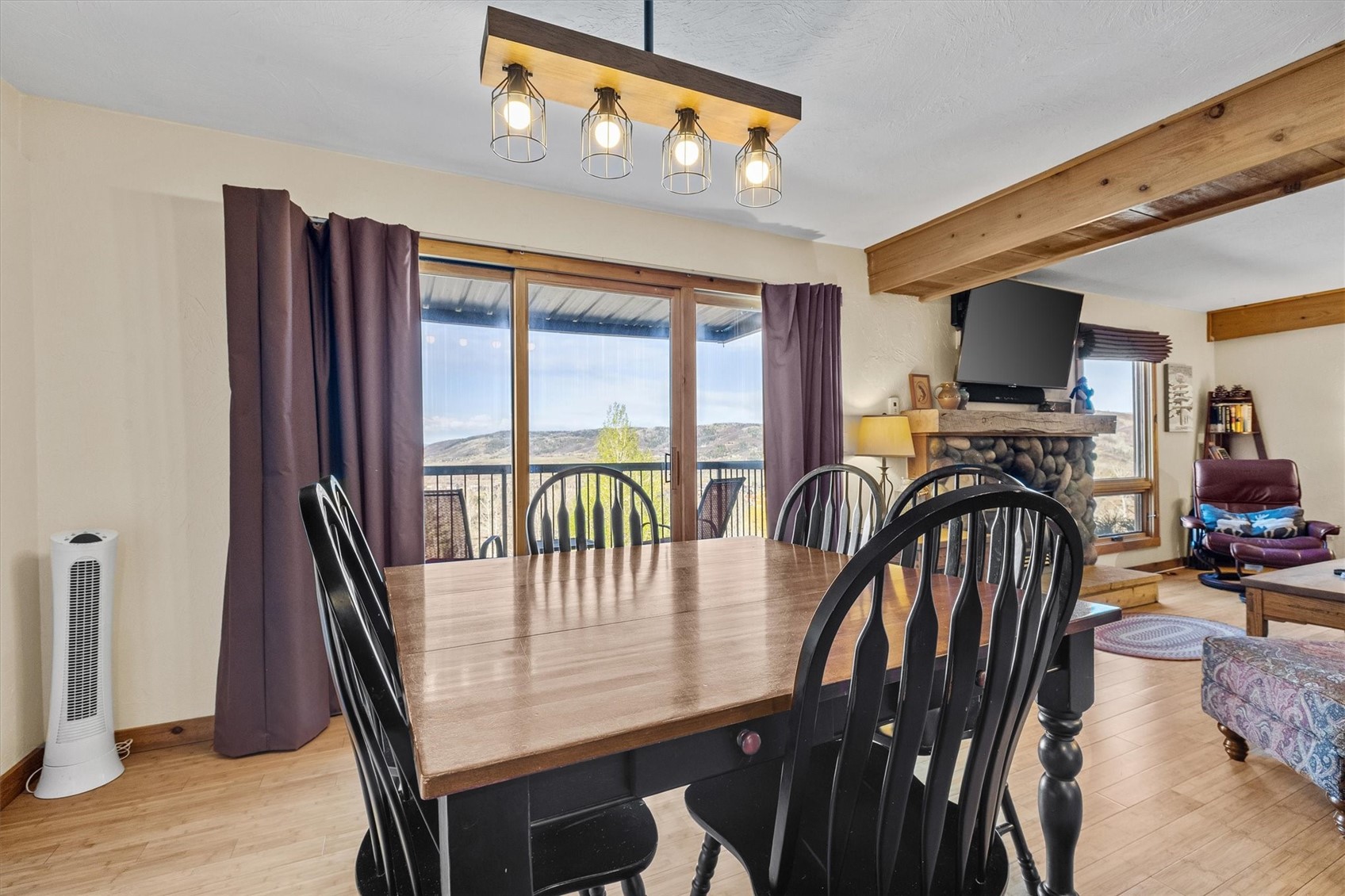 2602 Longthong Road, Unit 107 Steamboat Springs, CO 80487 - Photo 11 of 32 a dining room with furniture window and wooden floor
