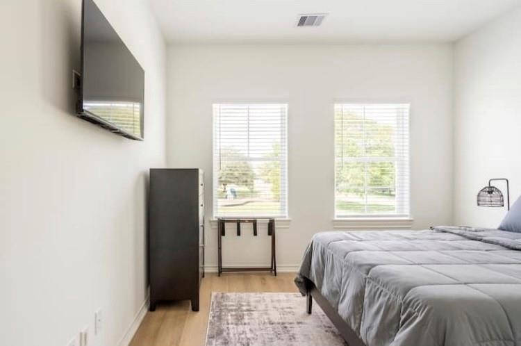3231 Real Street, Unit B Houston, TX 77087 - Photo 19 of 25 a bedroom with a bed cabinet and mirror