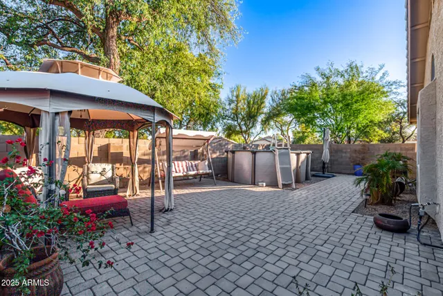 a view of a chairs and table in backyard of the house