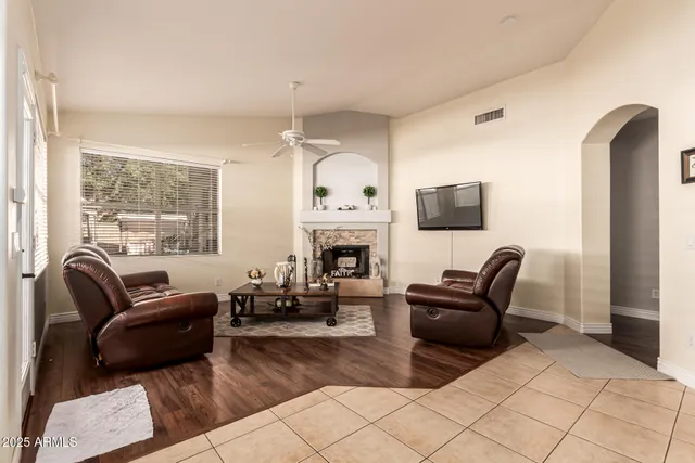a living room with furniture a fireplace and a flat screen tv
