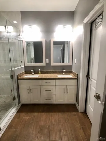 a spacious bathroom with a double vanity sink and a mirror