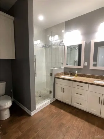 a spacious bathroom with a granite countertop sink mirror and toilet