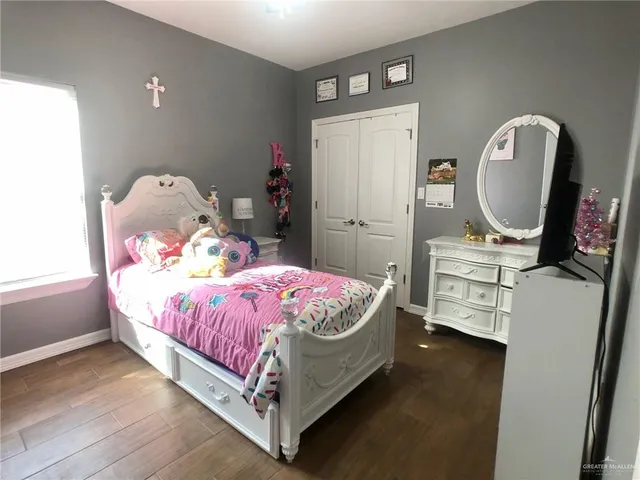 a bed sitting in a bedroom next to a window