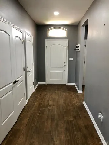 a view of a room with wooden floor