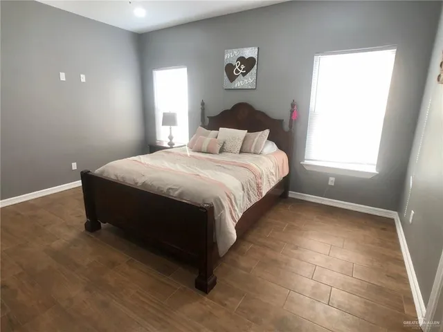 a spacious bedroom with a bed and a window