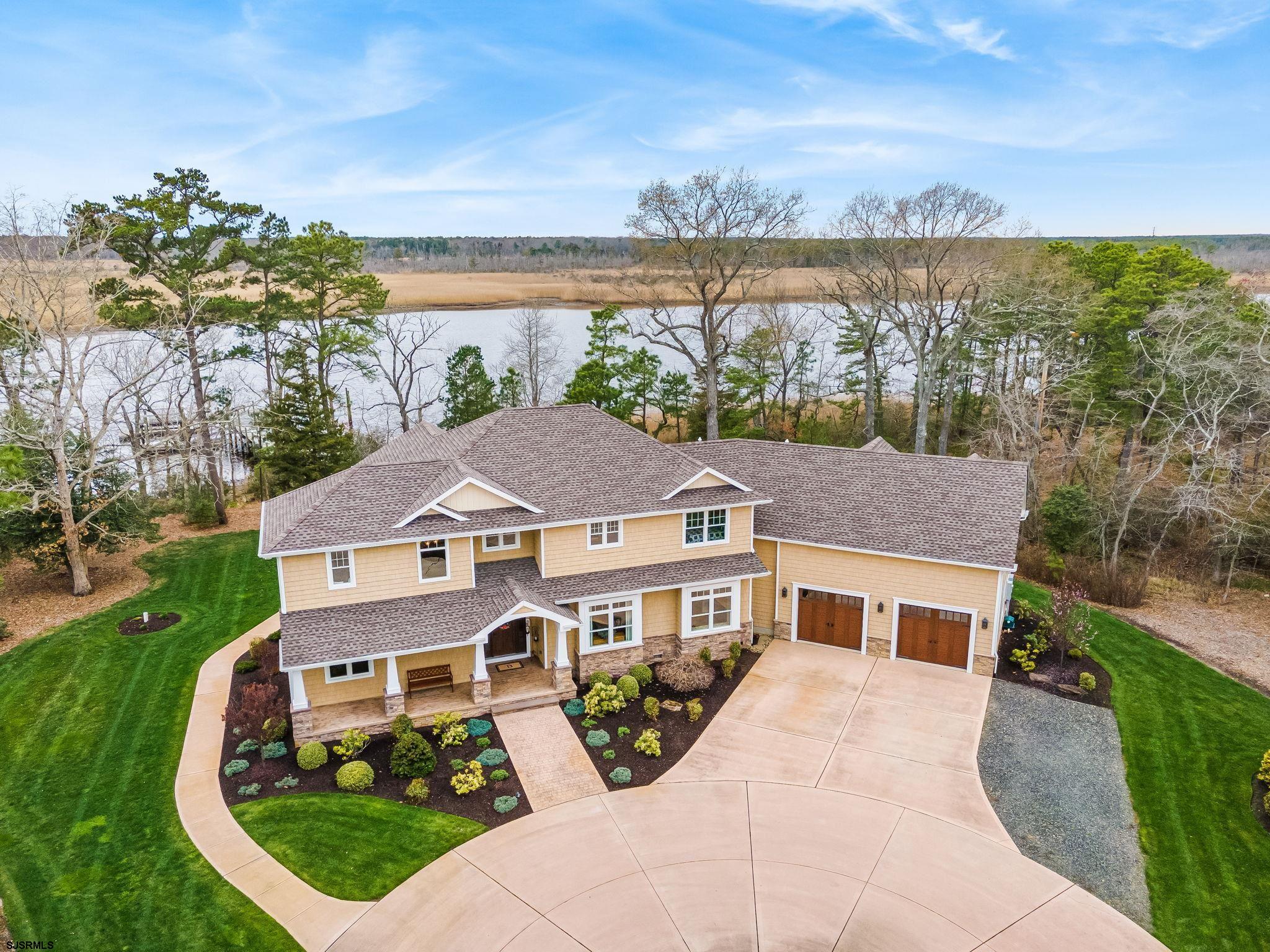 a aerial view of a house with a yard table and chairs