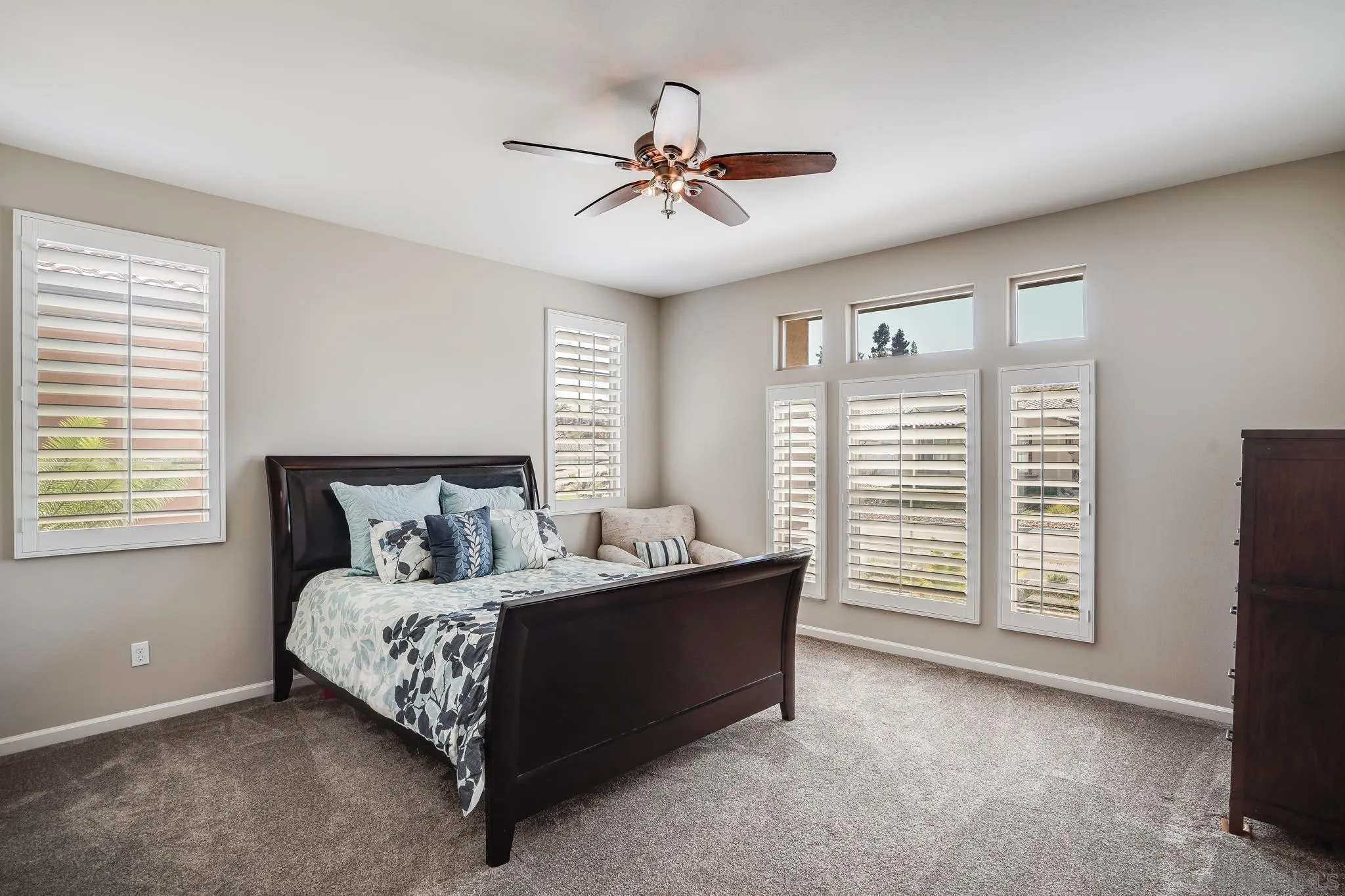 5662 Rancho Del Caballo Bonsall, CA 92003 - Photo 23 of 60 a bed room with a bed and a ceiling fan