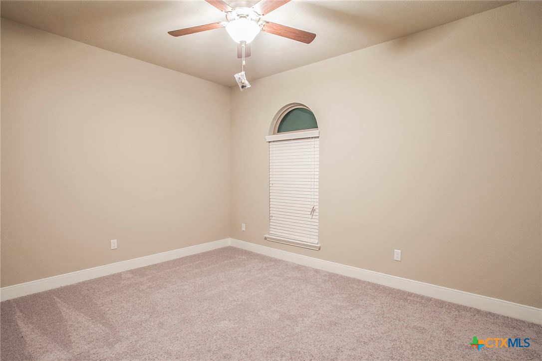 549 Wills Point Way Belton, TX 76513 - Photo 23 of 31 an empty room with chandelier fan and windows